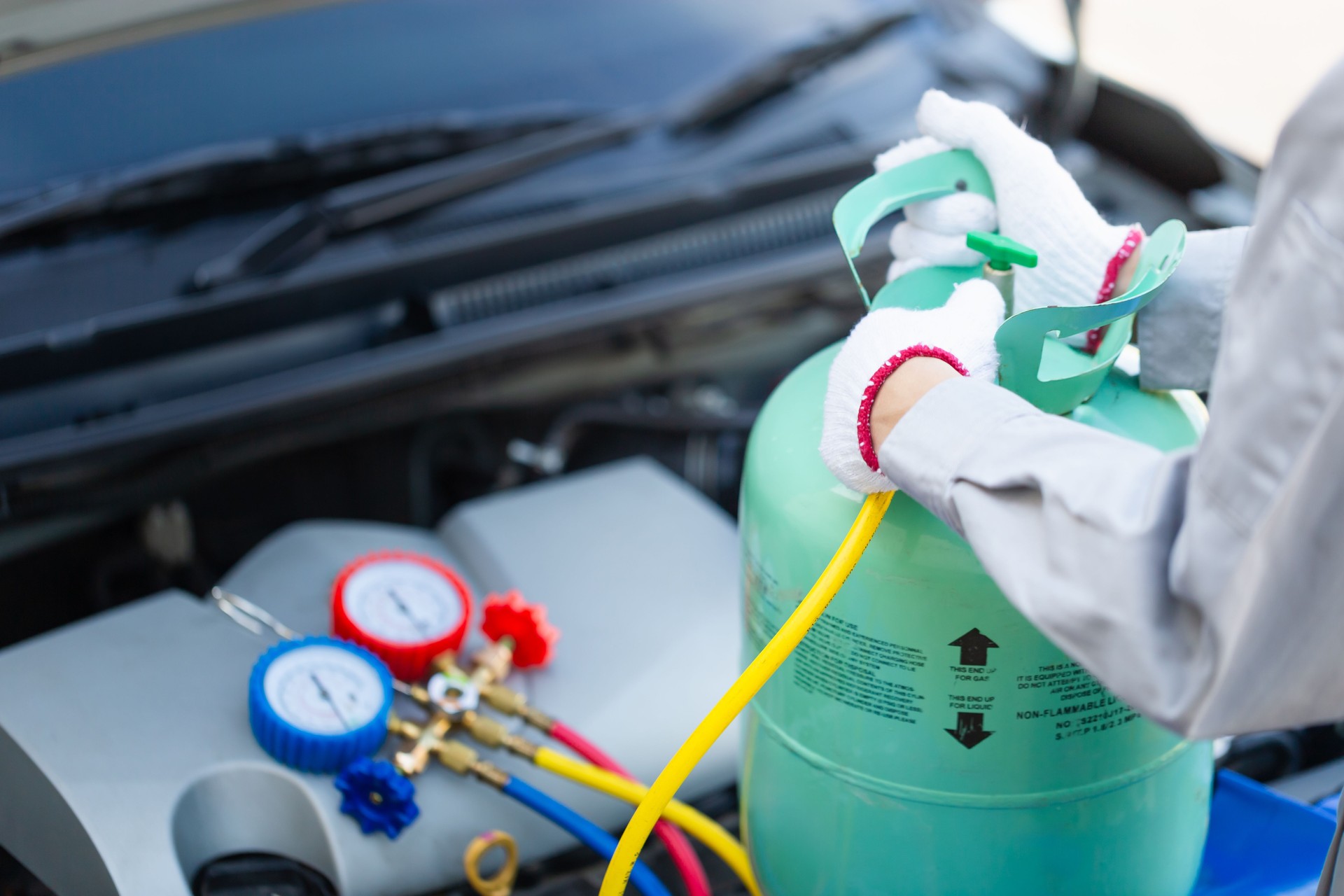 Car Air Conditioning Repair, Technician man check car air conditioning system refrigerant recharge, Repairman holding monitor tool to check and fixed car air conditioner system