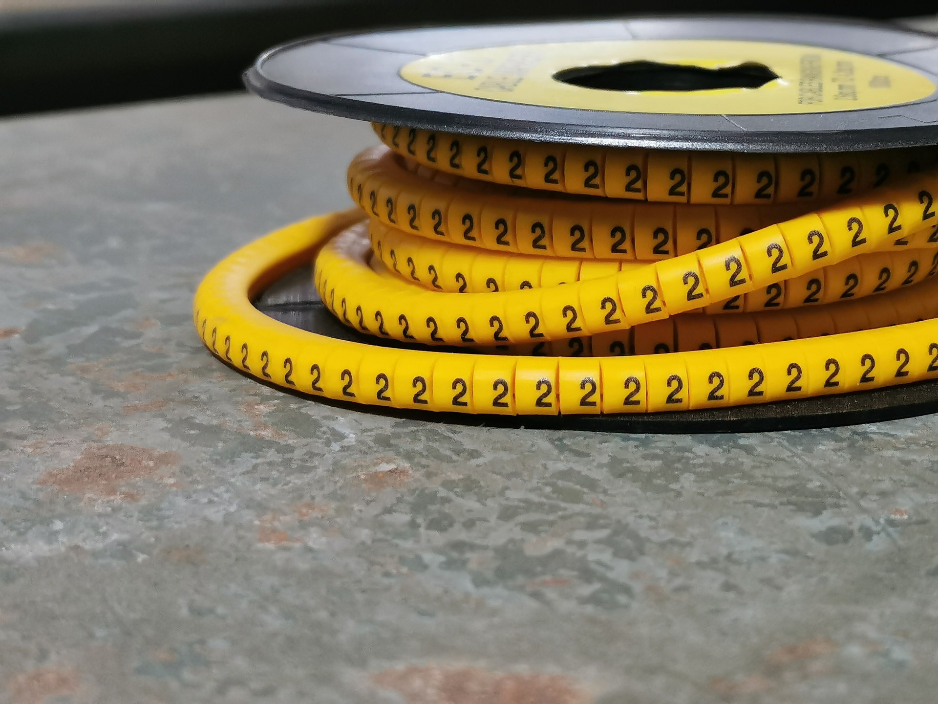 Yellow cable marker number two on the table.